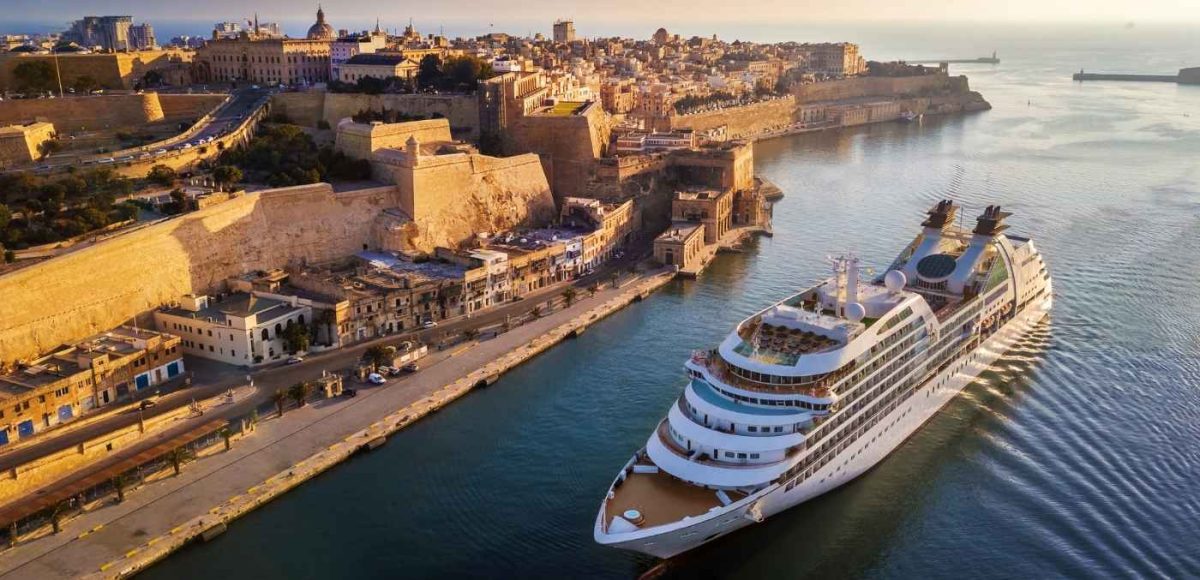 cruise ship pulling up to ancient european city