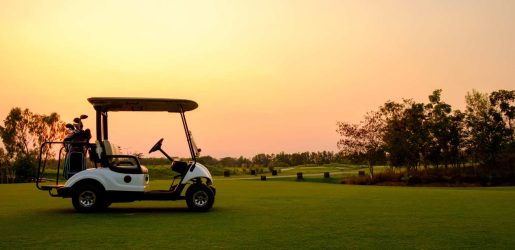 golf buggy on course at sunset