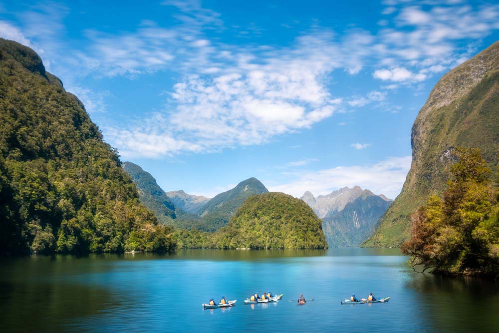 Kayaking into the incredible natural scenery and pristine waters of the fjord is an amazing experience at Deep Cove in Doubtful Sound, New Zealand, South Island