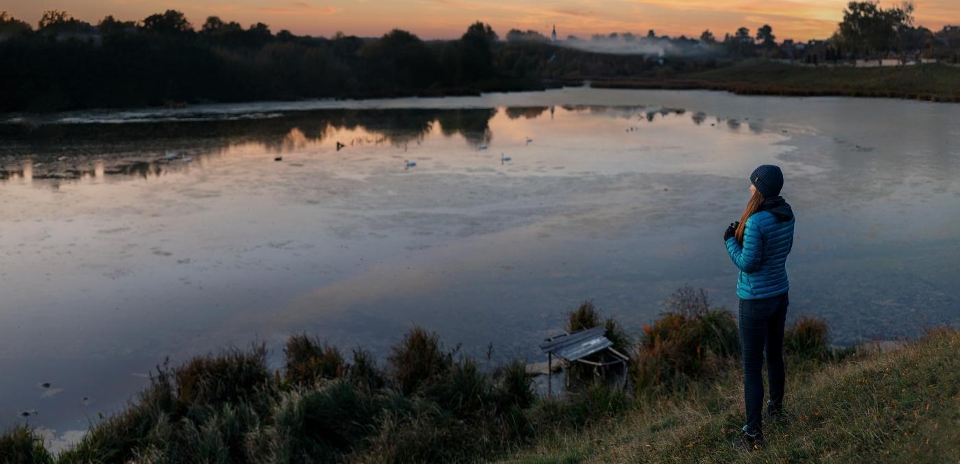 woman birdwatching at sunrise