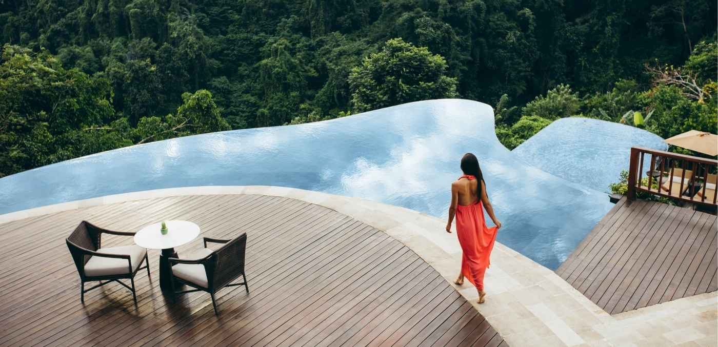 woman walking alongside a pool