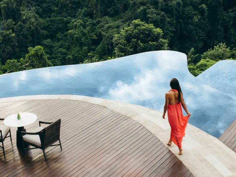 woman walking alongside a pool