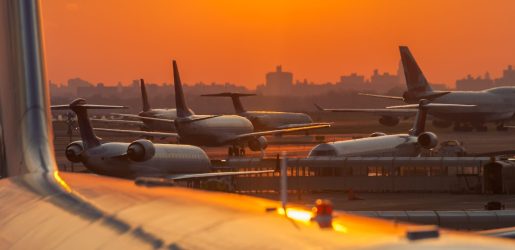 Sunset at the airport with airplanes ready to take off.
