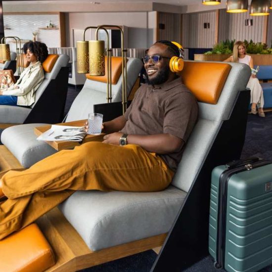 man sitting in recliner at airport lounge