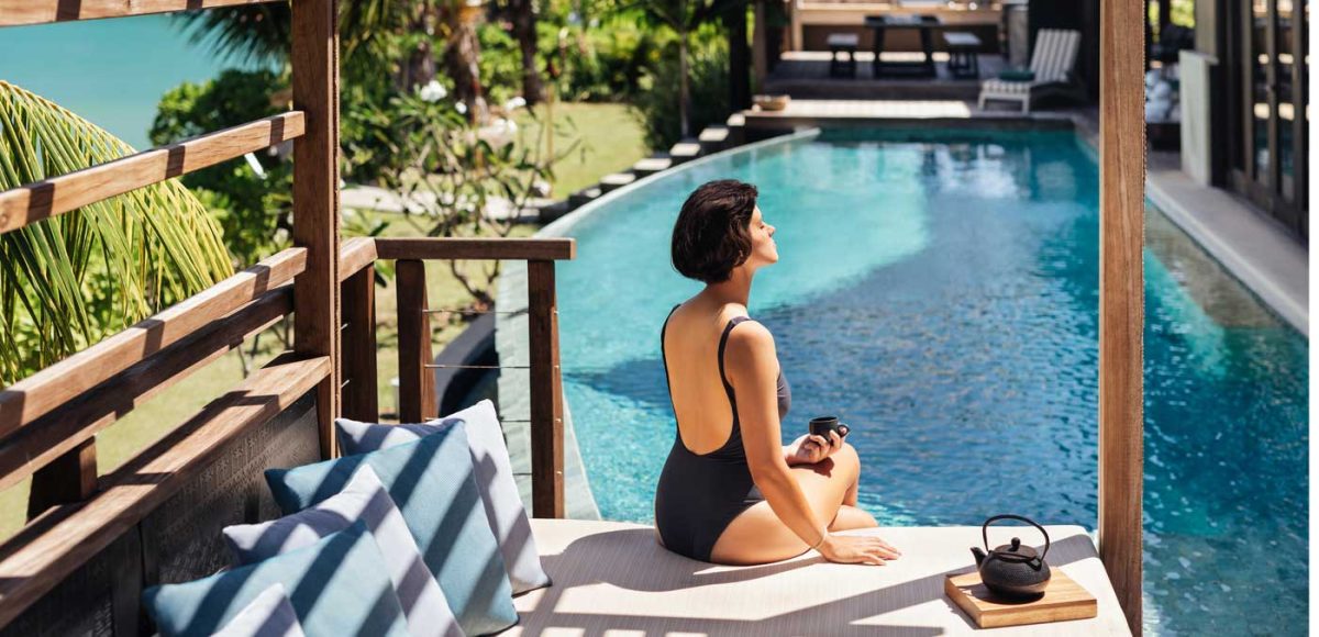 Woman relaxing by pool at Six Senses Fiji