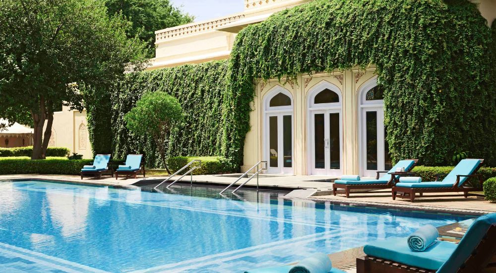 Pool with sun lounges in Indian palace